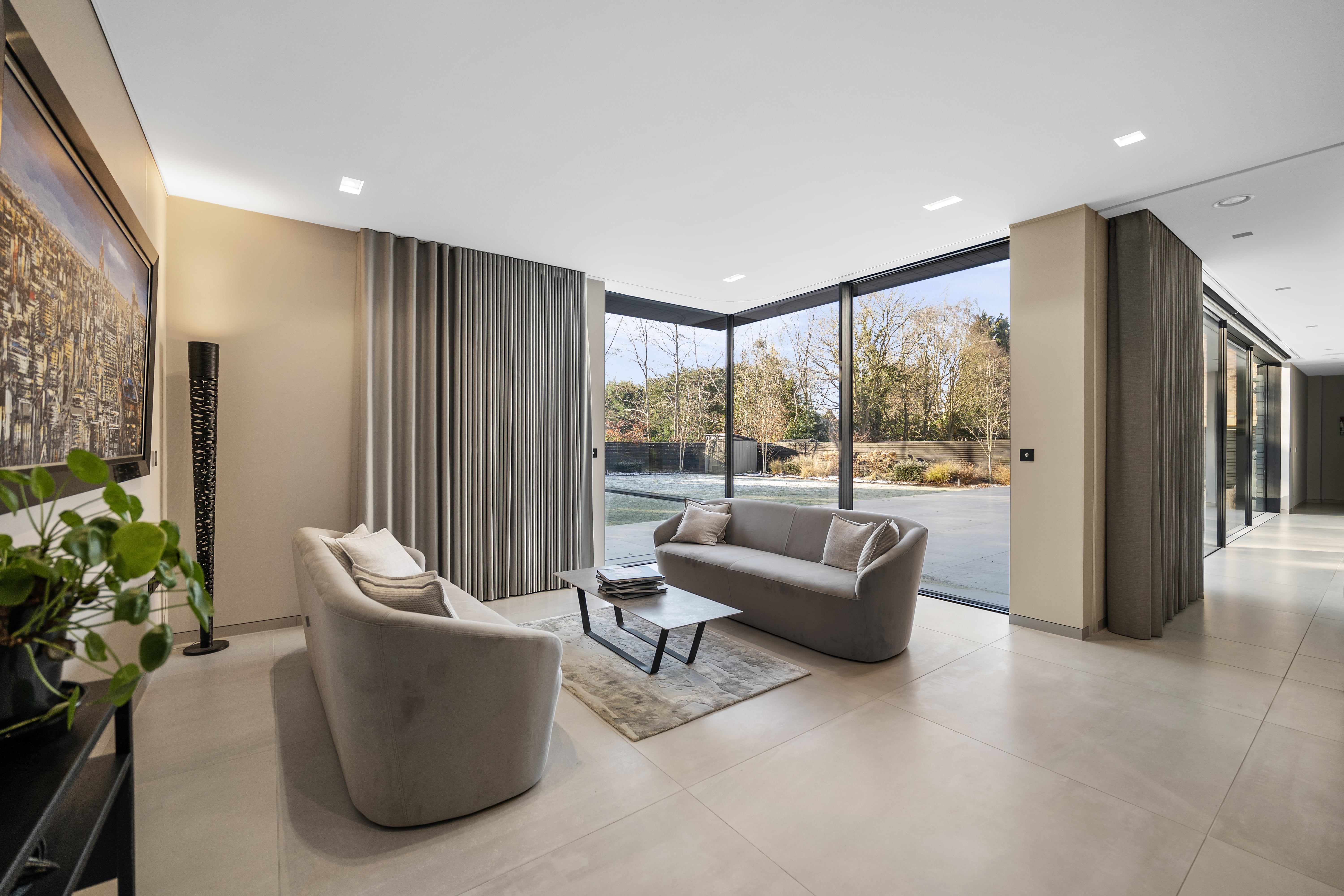 Open-plan living space with floor-to-ceiling windows, styled for guests