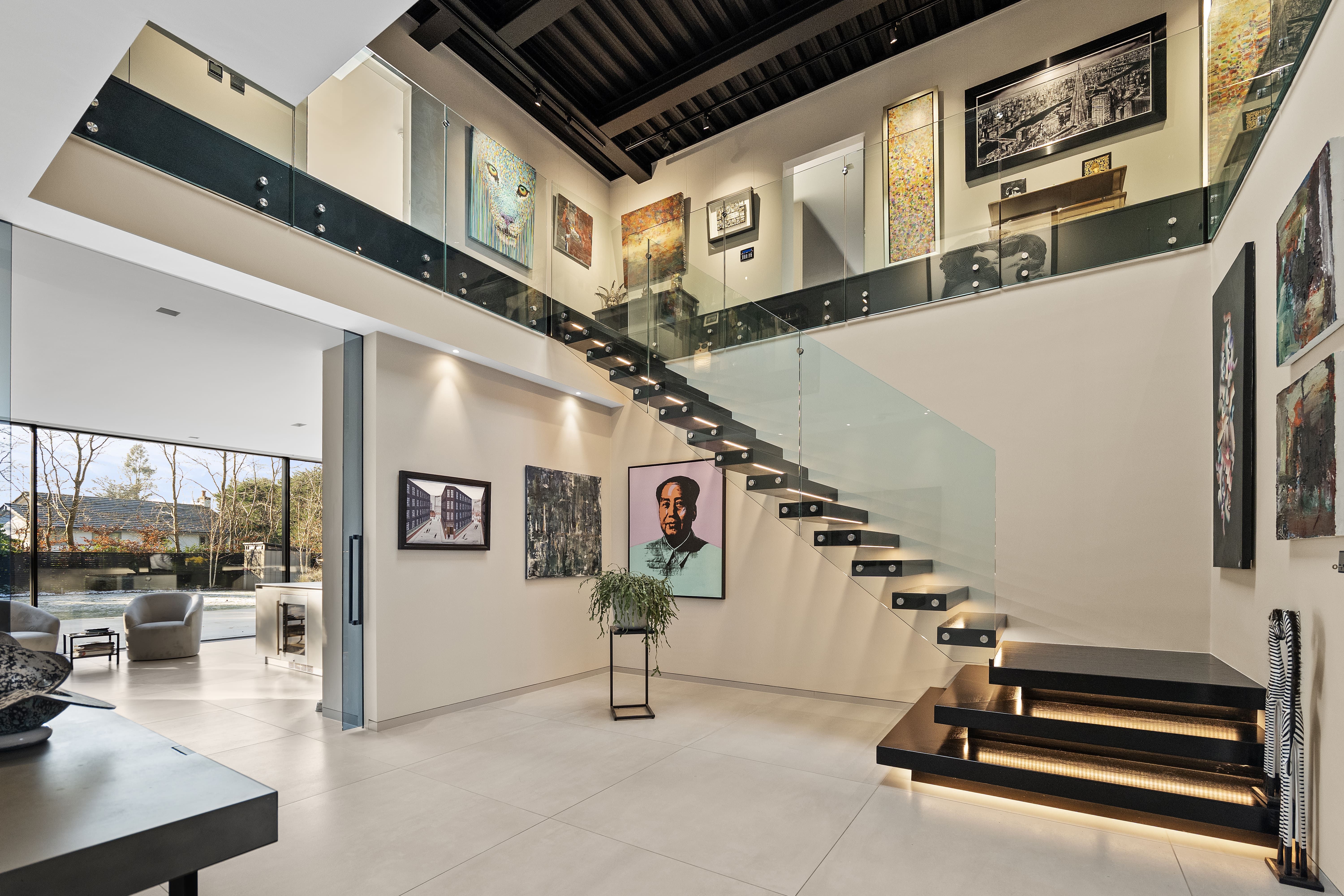Double-height entrance hall with a floating staircase