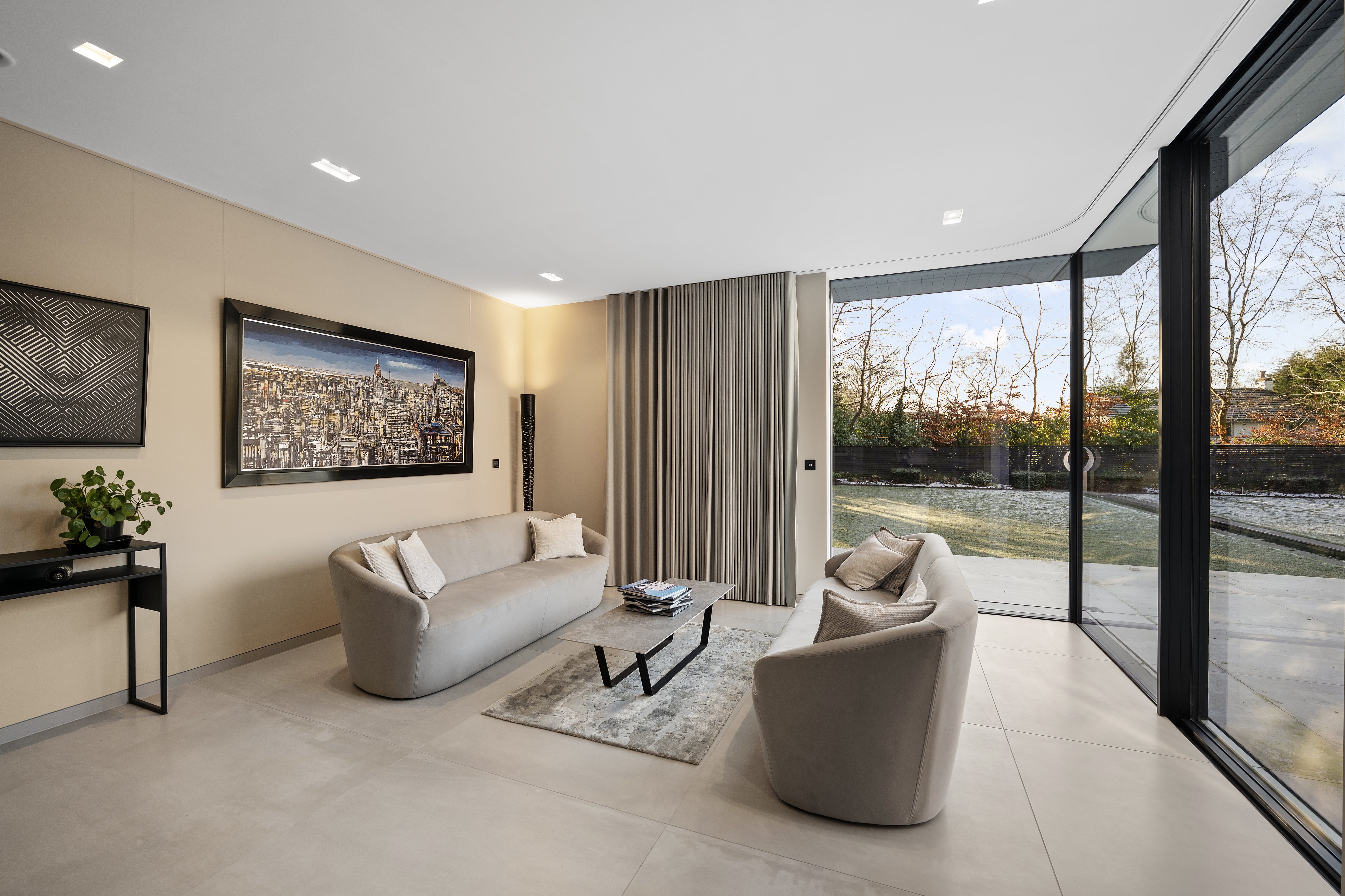 Sitting room opening onto the garden through full-height sliding doors